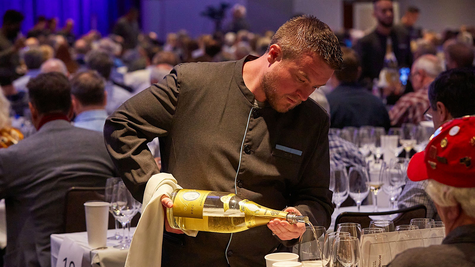 Server pouring a magnum of Cristal Brut Champagne 2008 for a guest at the 2022 New York Wine Experience